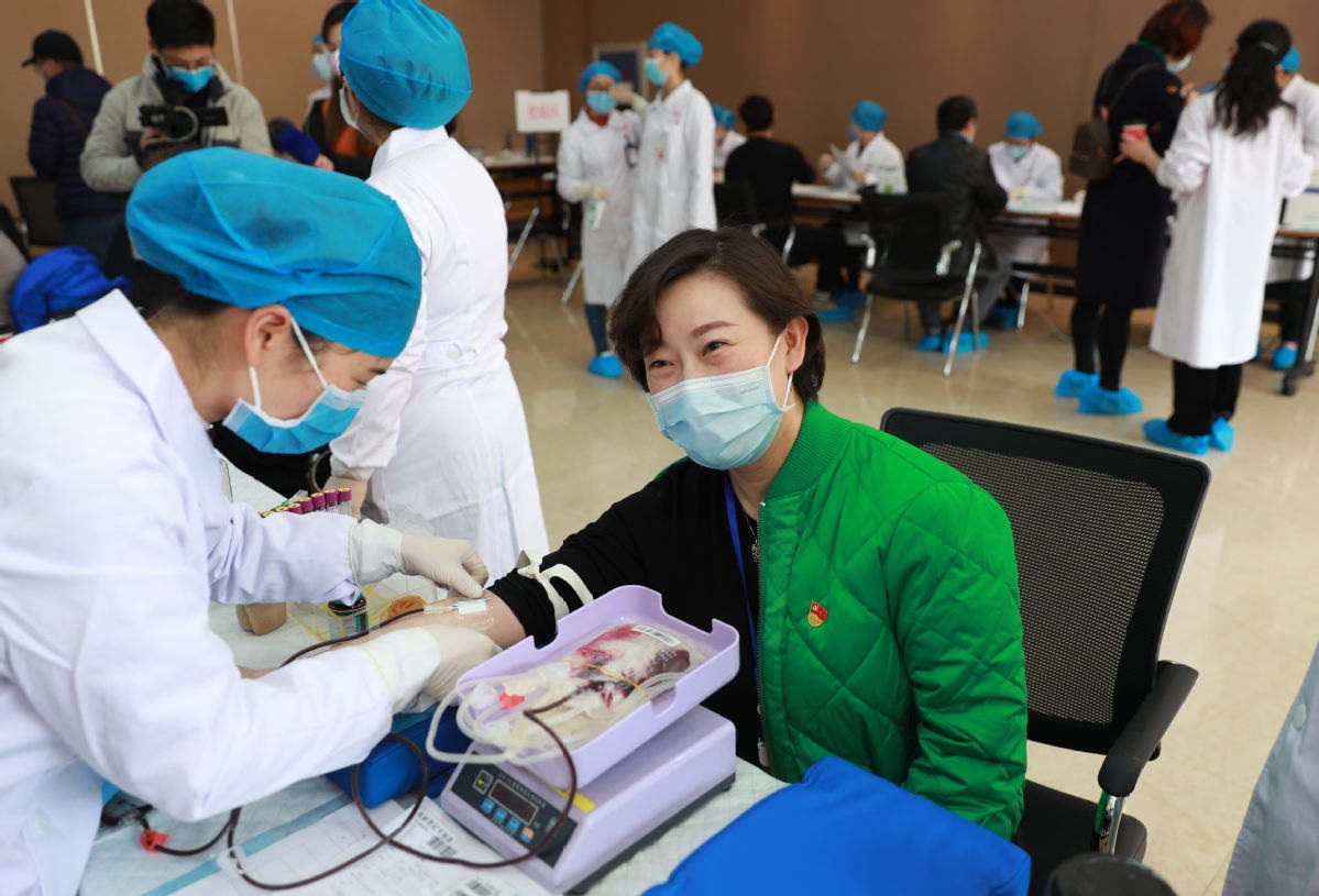 An employee of the Wuhan Blood Center donates blood in Wuhan